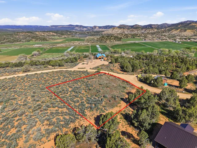 Overview of landscape with property boundaries highlighted and a mountainous background