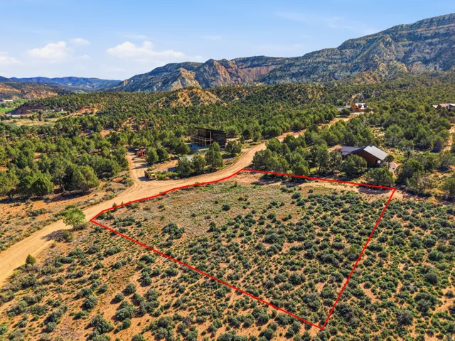 Aerial overview of property's location featuring property boundaries highlighted and a mountain backdrop