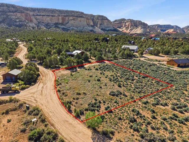 View of area with property boundaries highlighted and a mountainous background