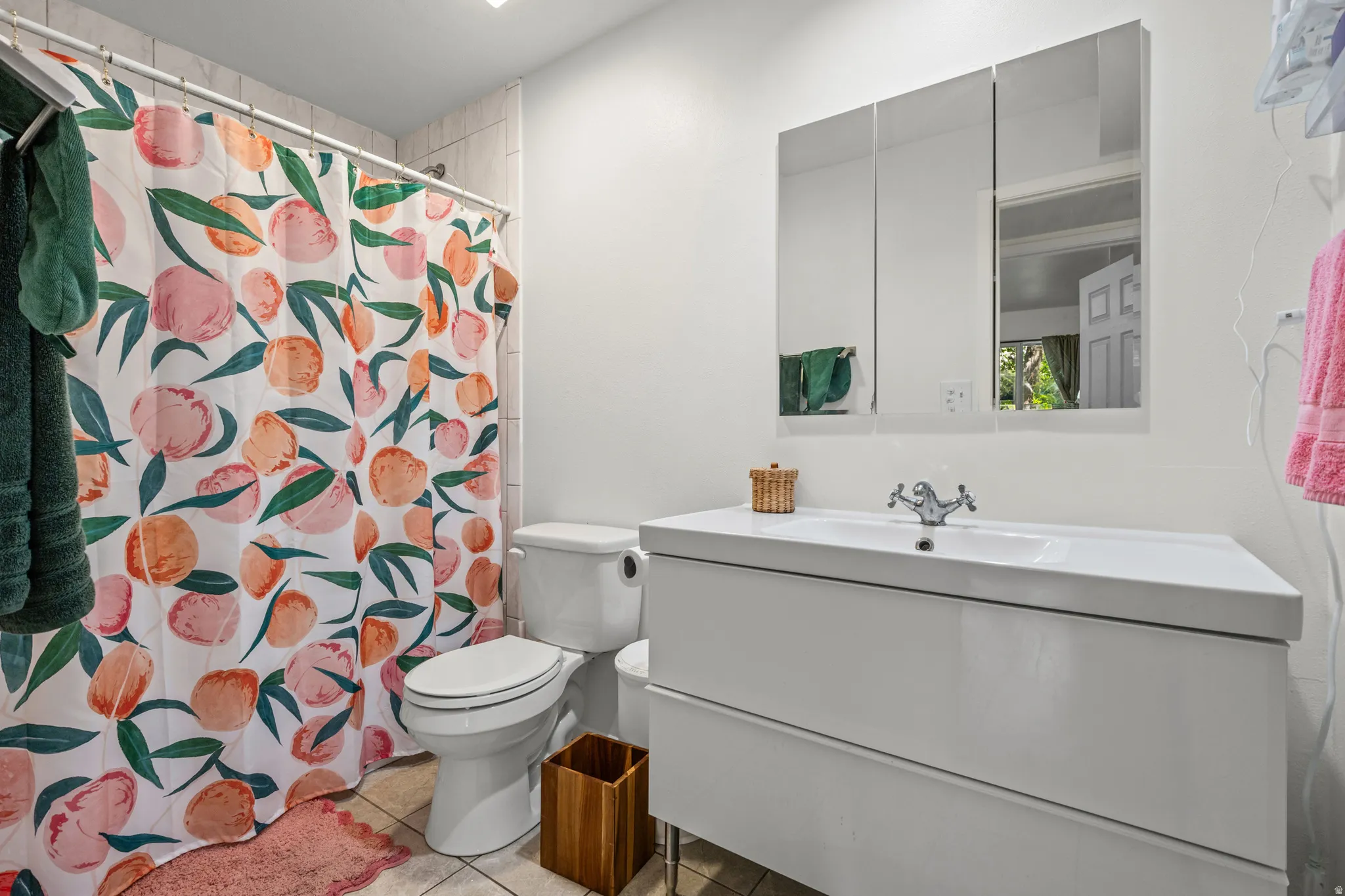 Bathroom featuring vanity, a shower with curtain, and light tile patterned flooring