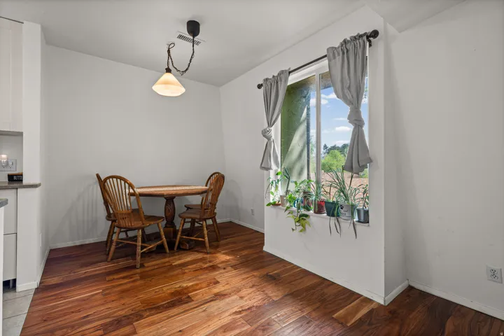 Dining space with hardwood flooring and baseboards