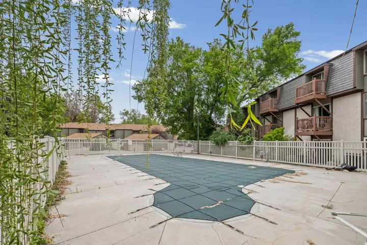 Community pool with a patio