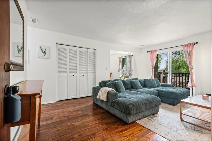 Living room featuring hardwood flooring and a textured ceiling