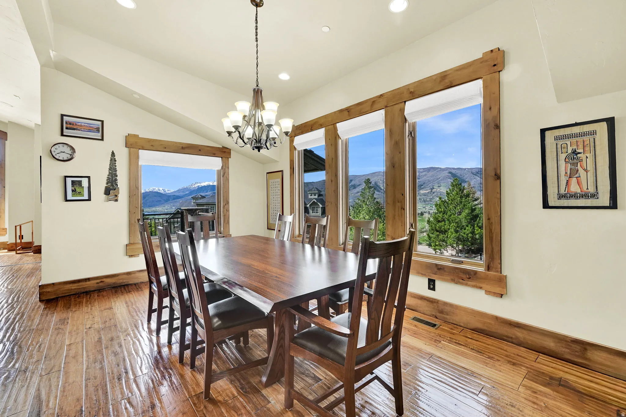 Dining room featuring a mountain view, hardwood / wood-style flooring, plenty of natural light, a chandelier, and vaulted ceiling