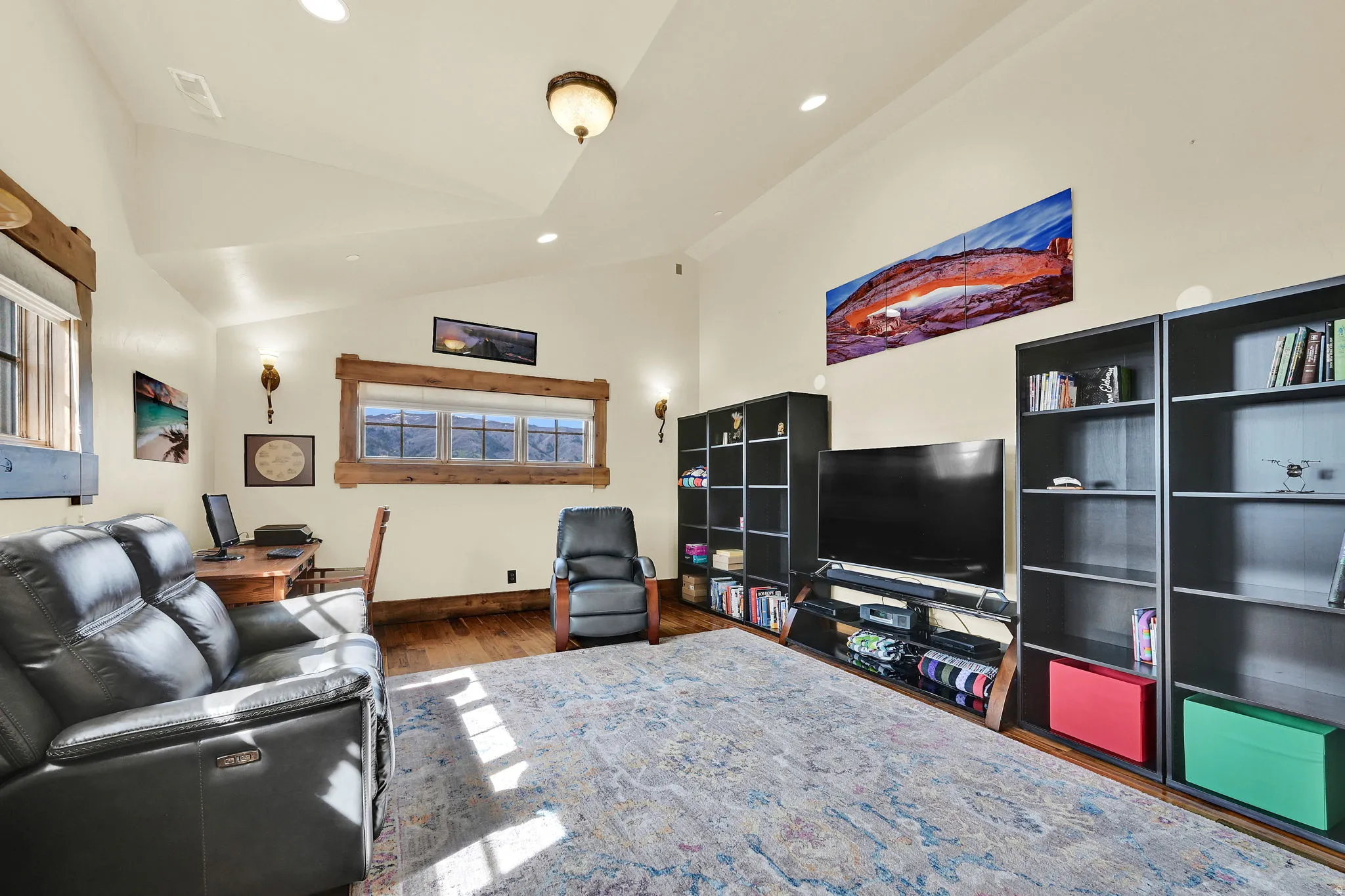 Living area with lofted ceiling, recessed lighting, and dark wood finished floors