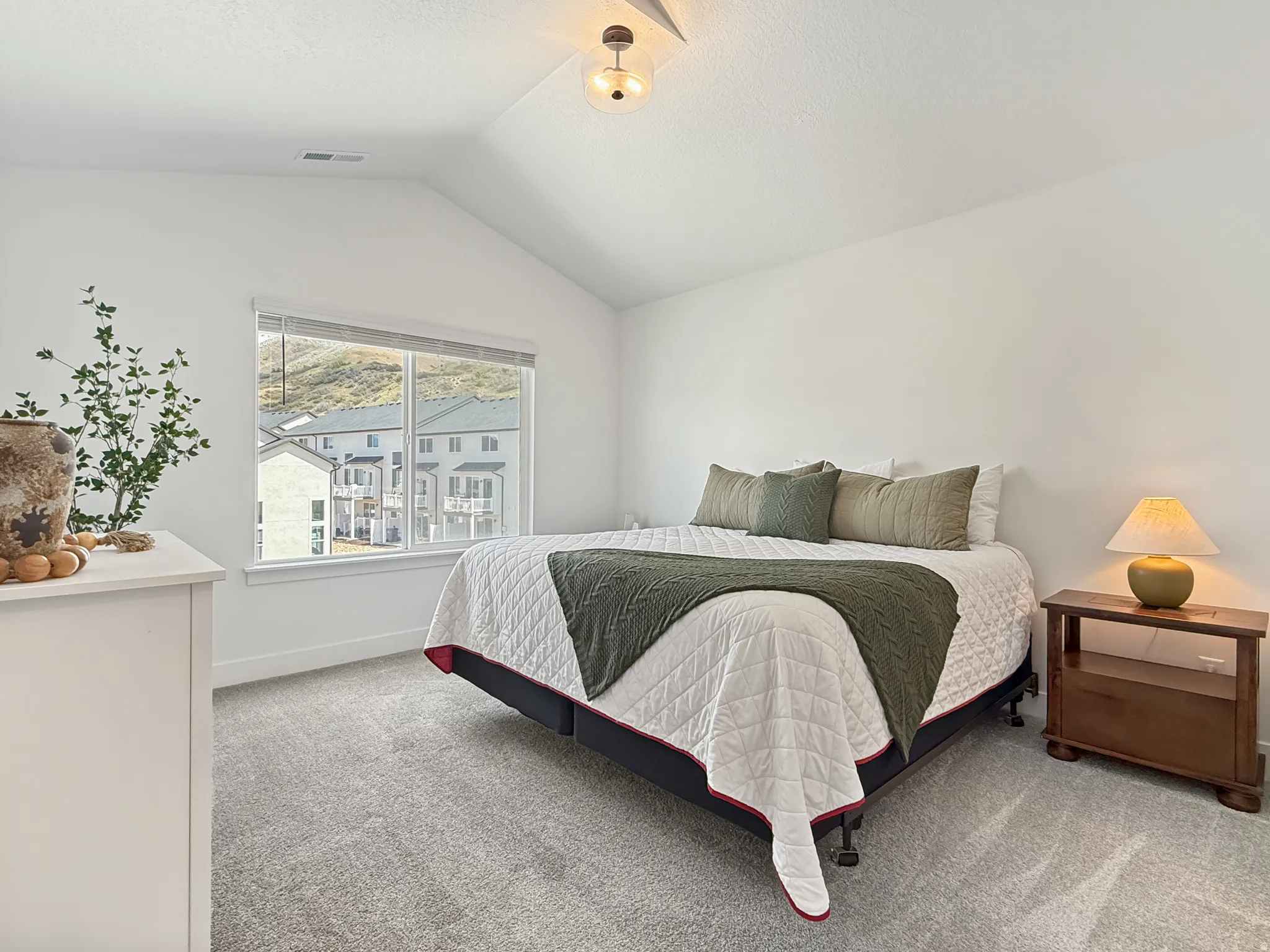 Bedroom featuring light carpet and baseboards