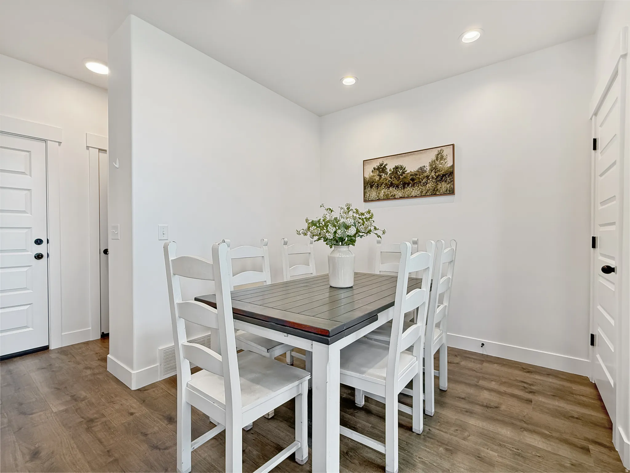 Dining room featuring wood finished floors and recessed lighting
