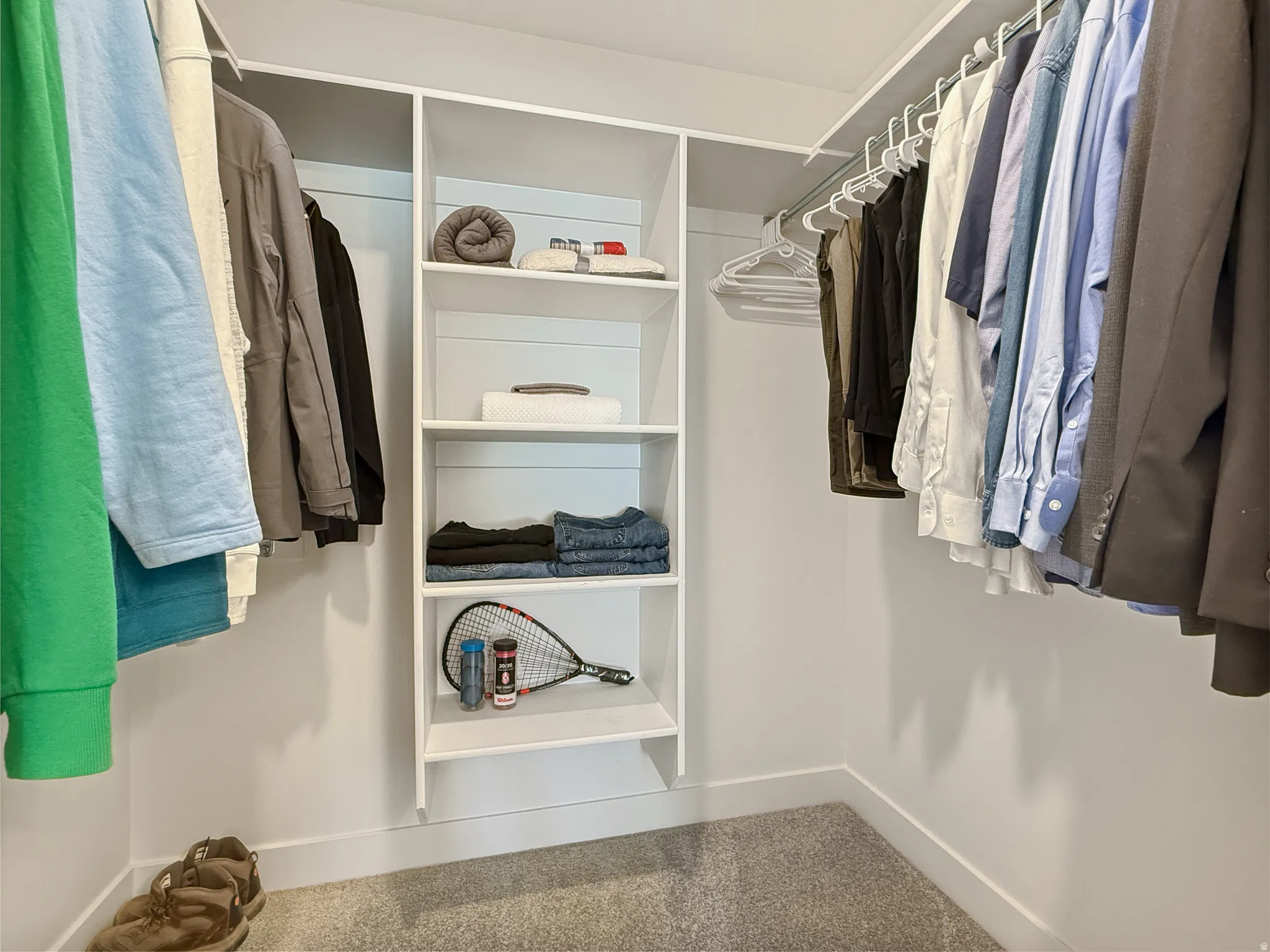 Walk in closet with carpet flooring
