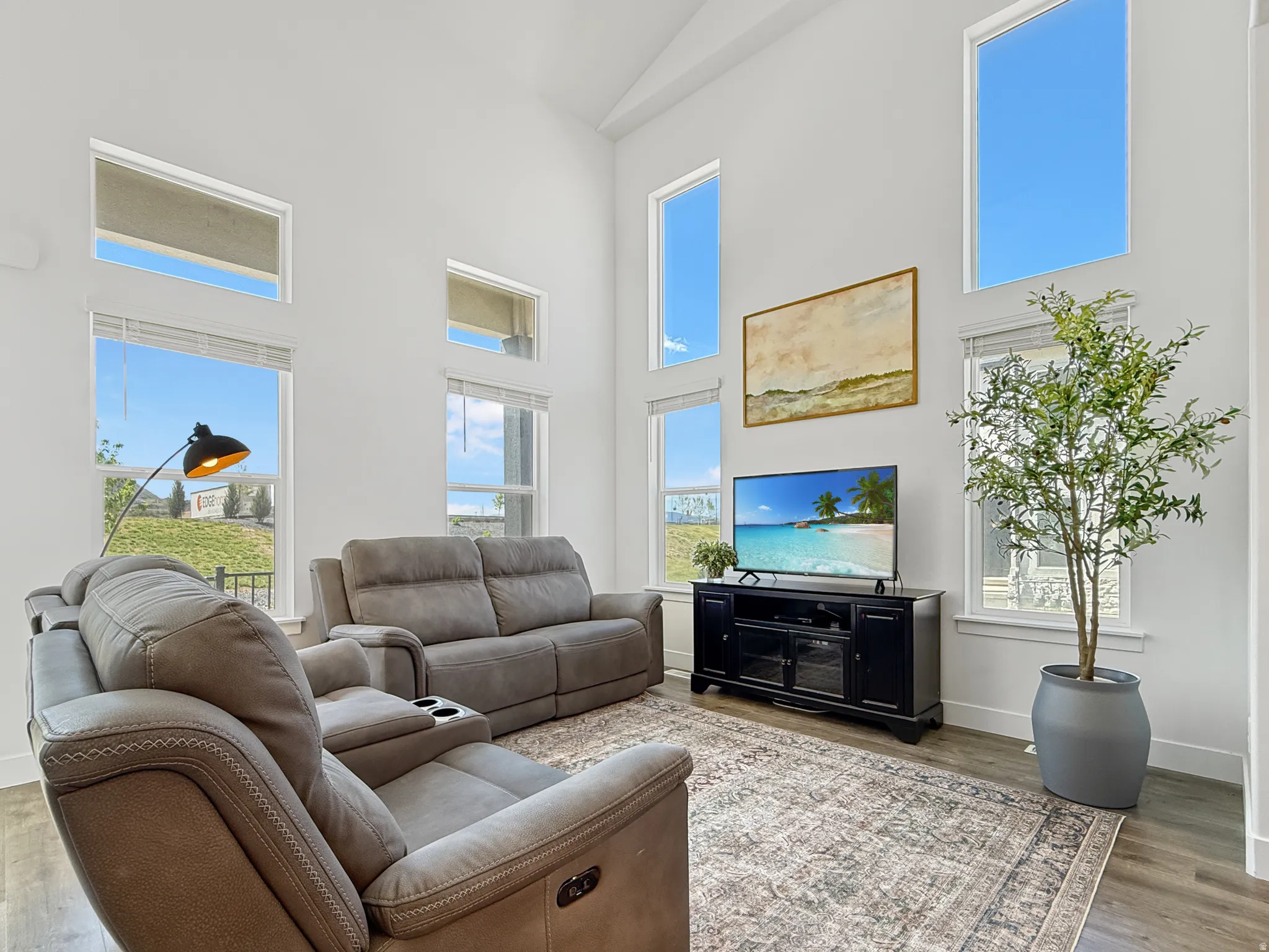 Living area with a high ceiling and wood finished floors