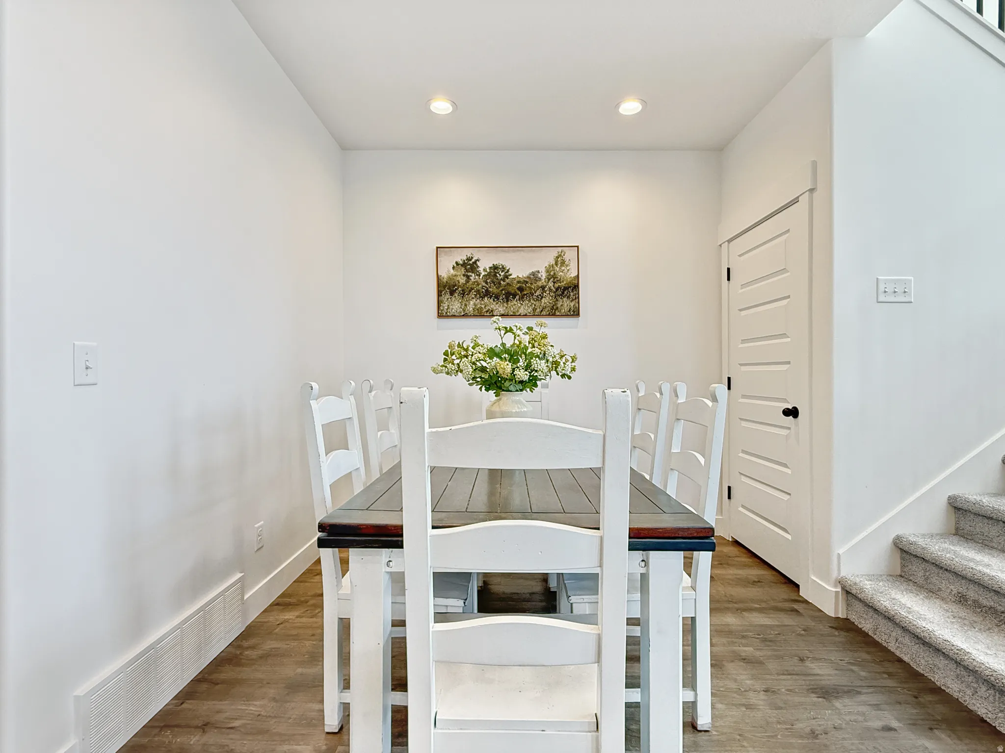 Dining area with recessed lighting and wood finished floors