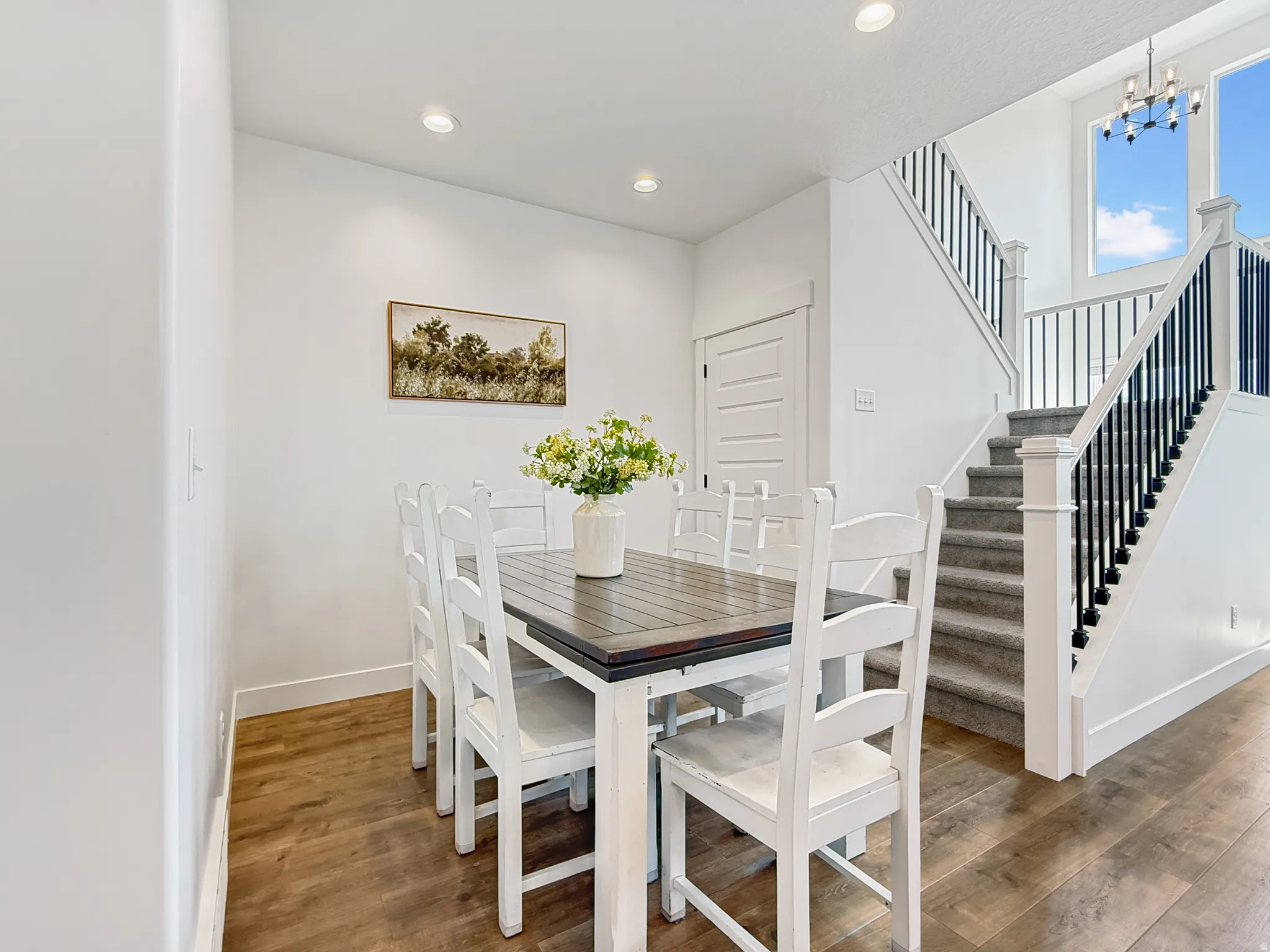 Dining room featuring wood finished floors and suspended lighting