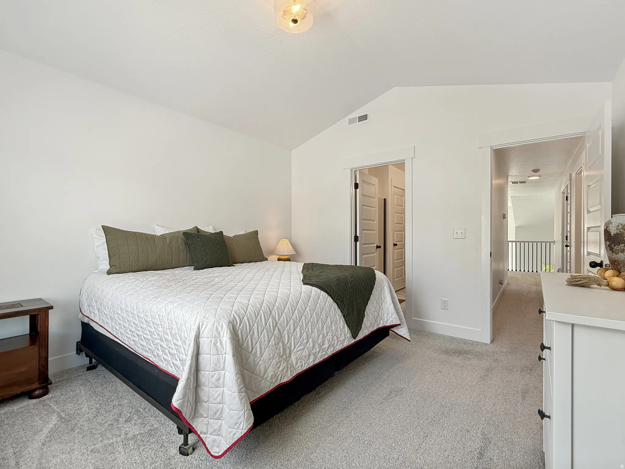 Bedroom featuring light carpet and baseboards
