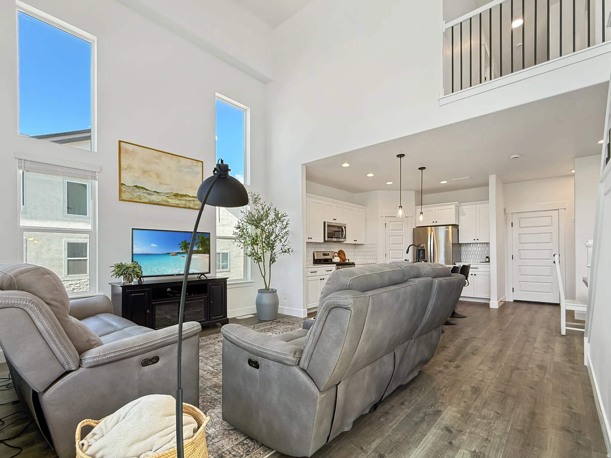 Living area featuring a high ceiling and dark wood finished floors