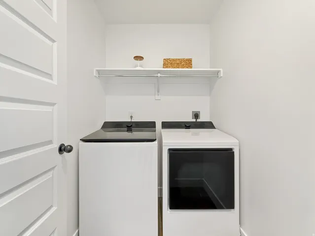 Laundry area with washing machine and clothes dryer