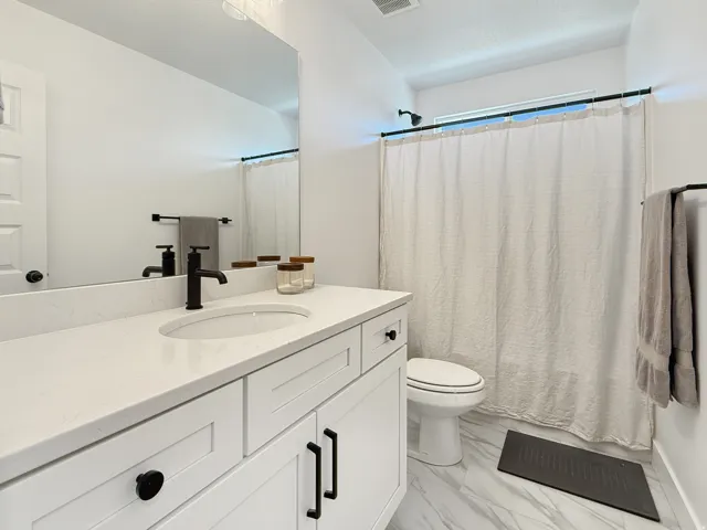 Full bathroom with vanity and light marble finish flooring