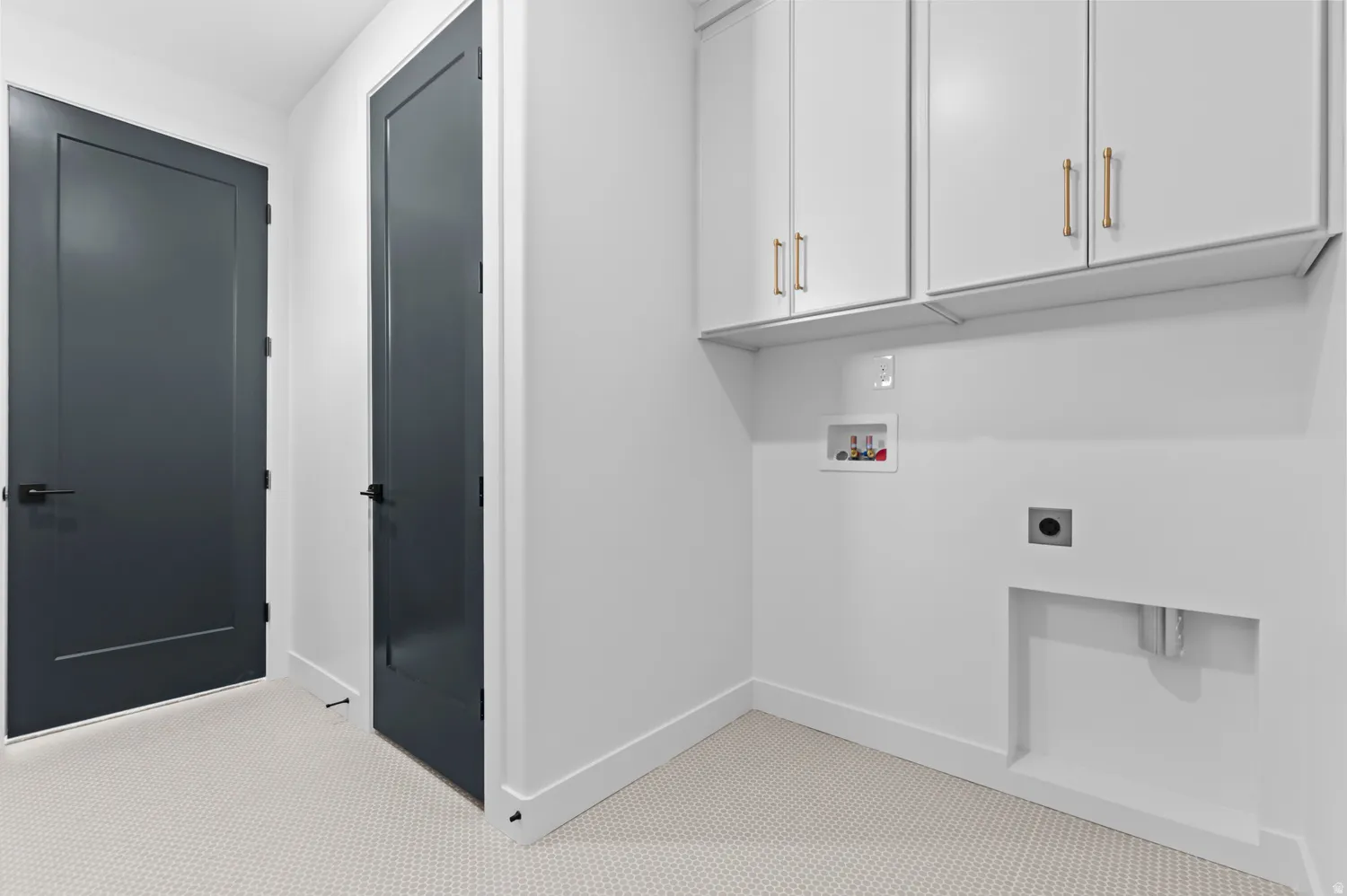 Laundry room featuring electric dryer hookup, hookup for a washing machine, and cabinet space
