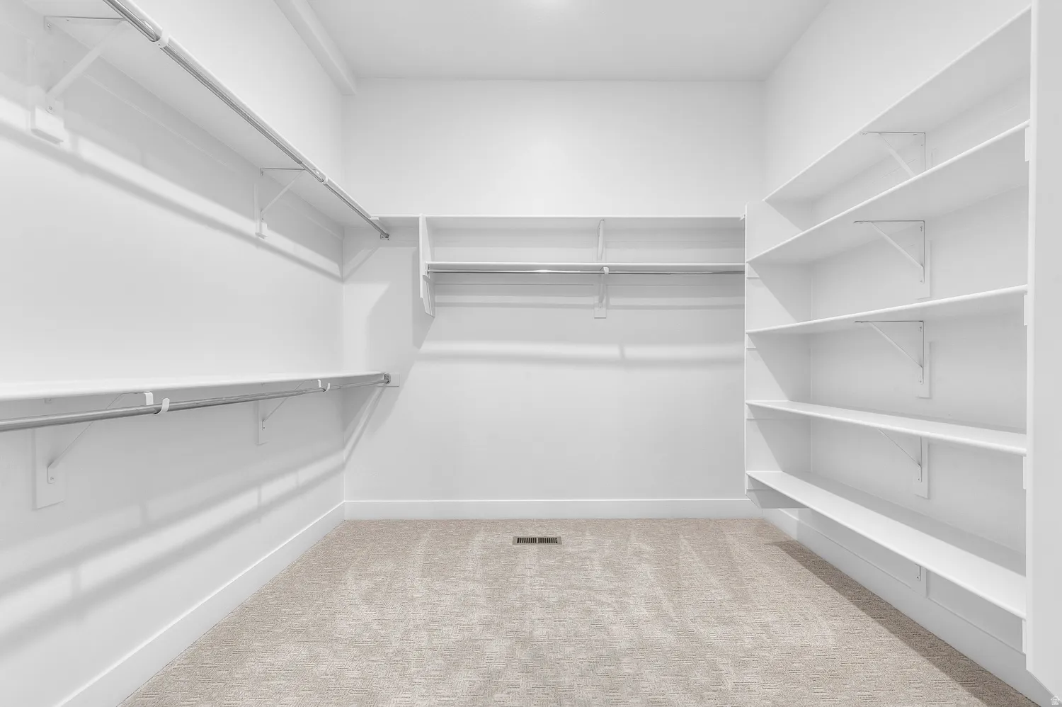 Walk in closet featuring light carpet