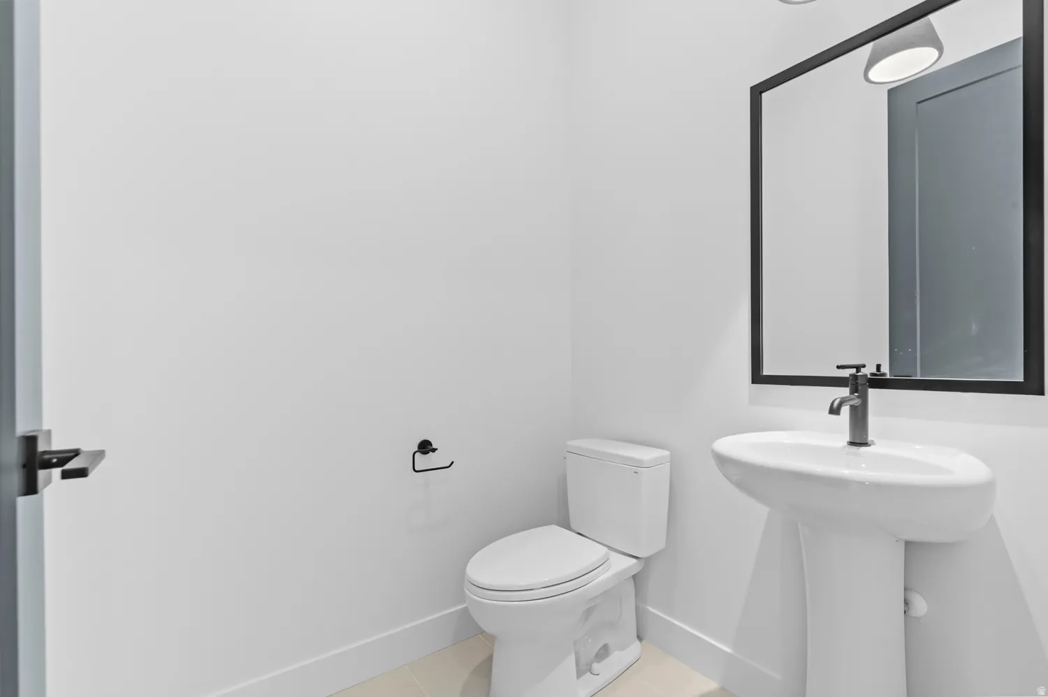 Bathroom with toilet and light tile patterned floors