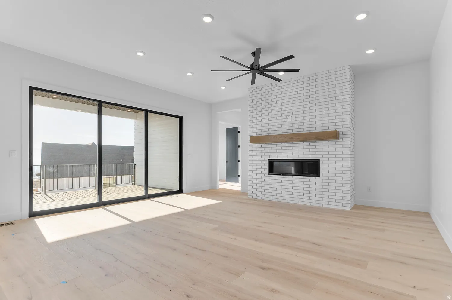 Unfurnished living room with a ceiling fan, light wood-style floors, a fireplace, and recessed lighting