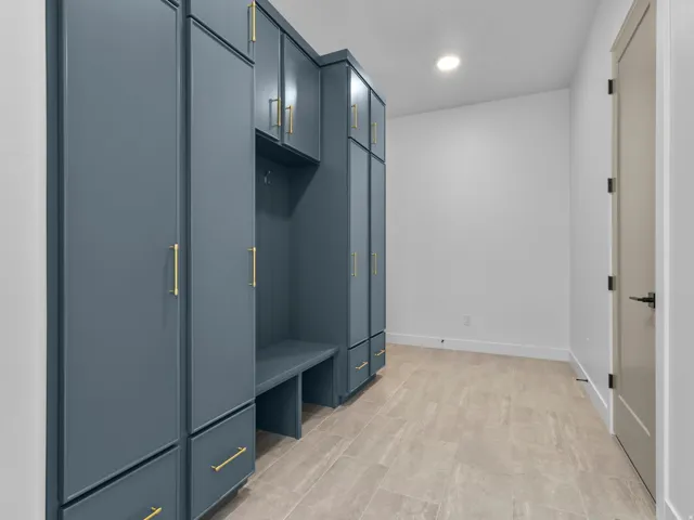 Built-in cabinetry with a blue finish and gold hardware