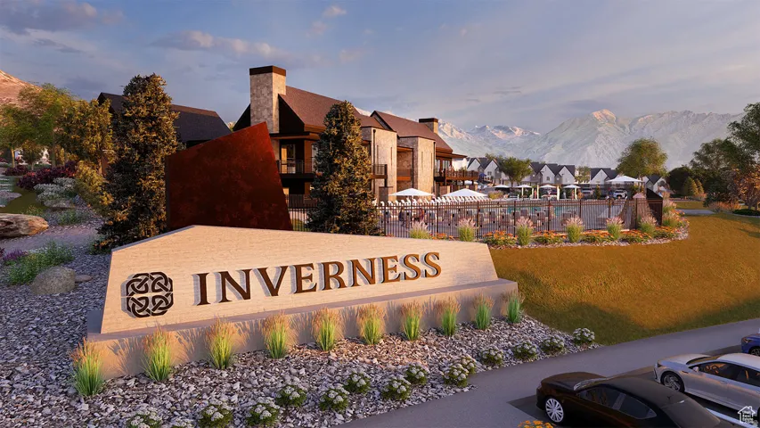 Community sign featuring a mountain view and a lawn