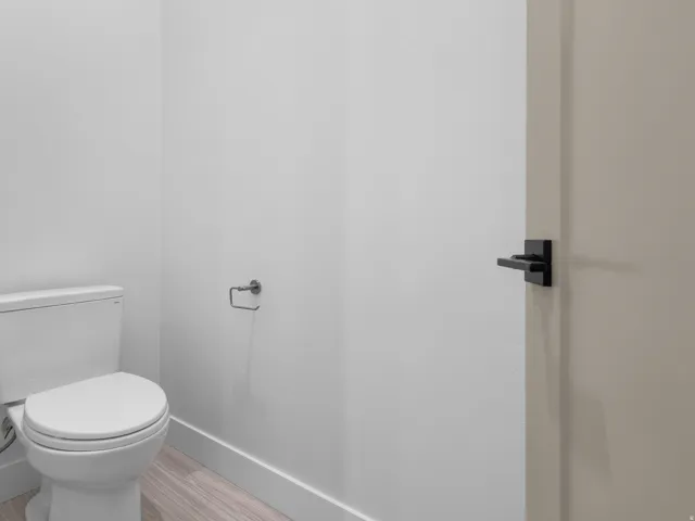 White toilet with a round bowl and tank
