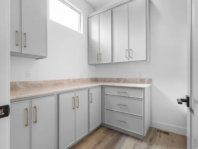 Custom cabinetry with gold-tone hardware, providing abundant storage