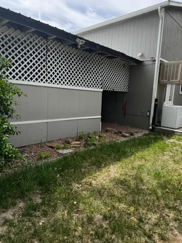View of property exterior featuring washer / clothes dryer and a yard