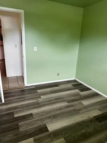 Unfurnished room featuring dark wood finished floors