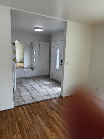 Foyer with light wood-style flooring and baseboards