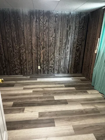 Detailed view of wood finished floors and wooden walls