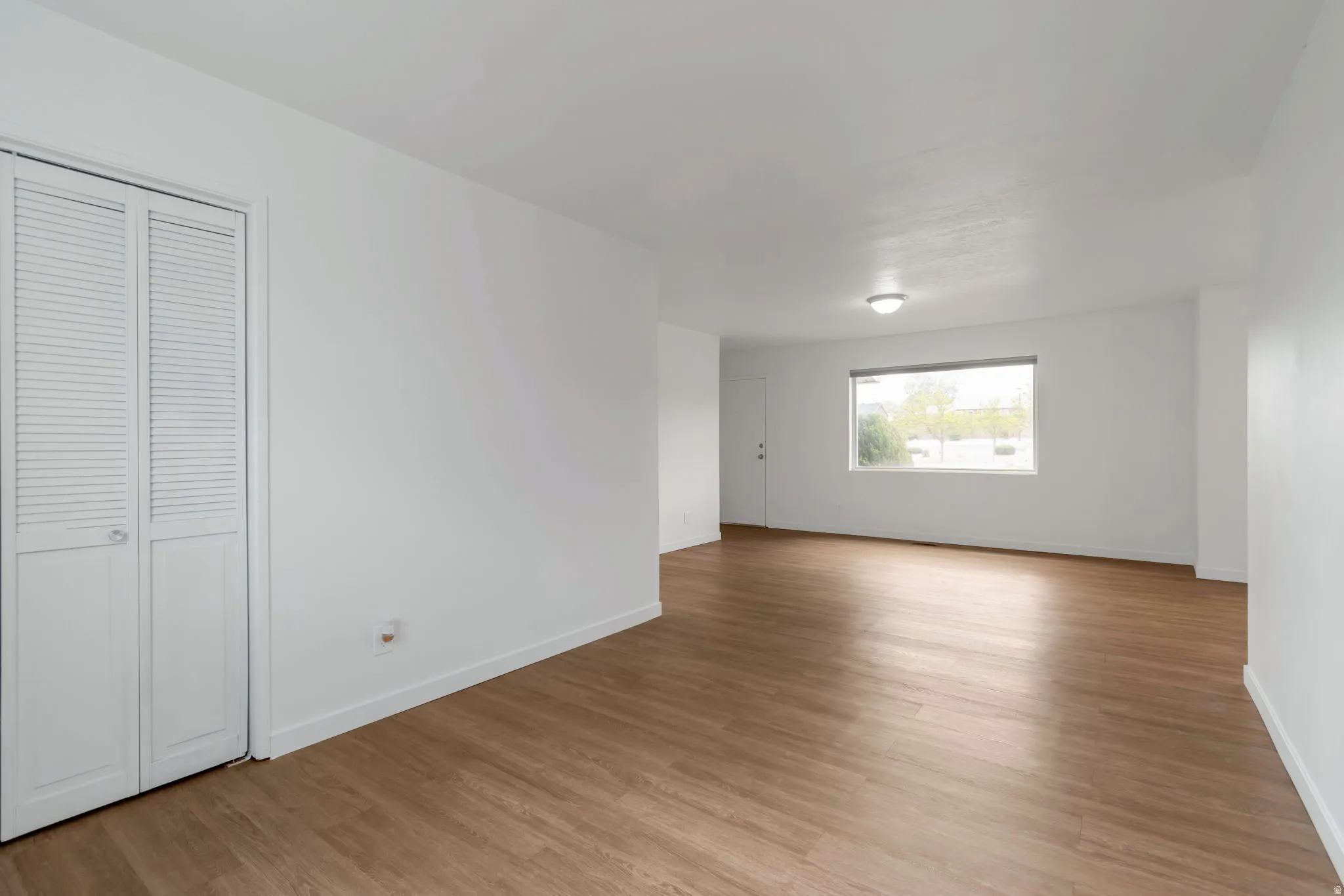 Unfurnished bedroom with light wood-type flooring and a closet