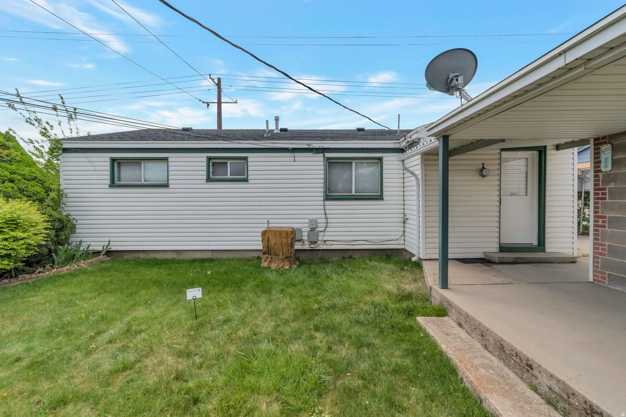 Rear view of house featuring a lawn
