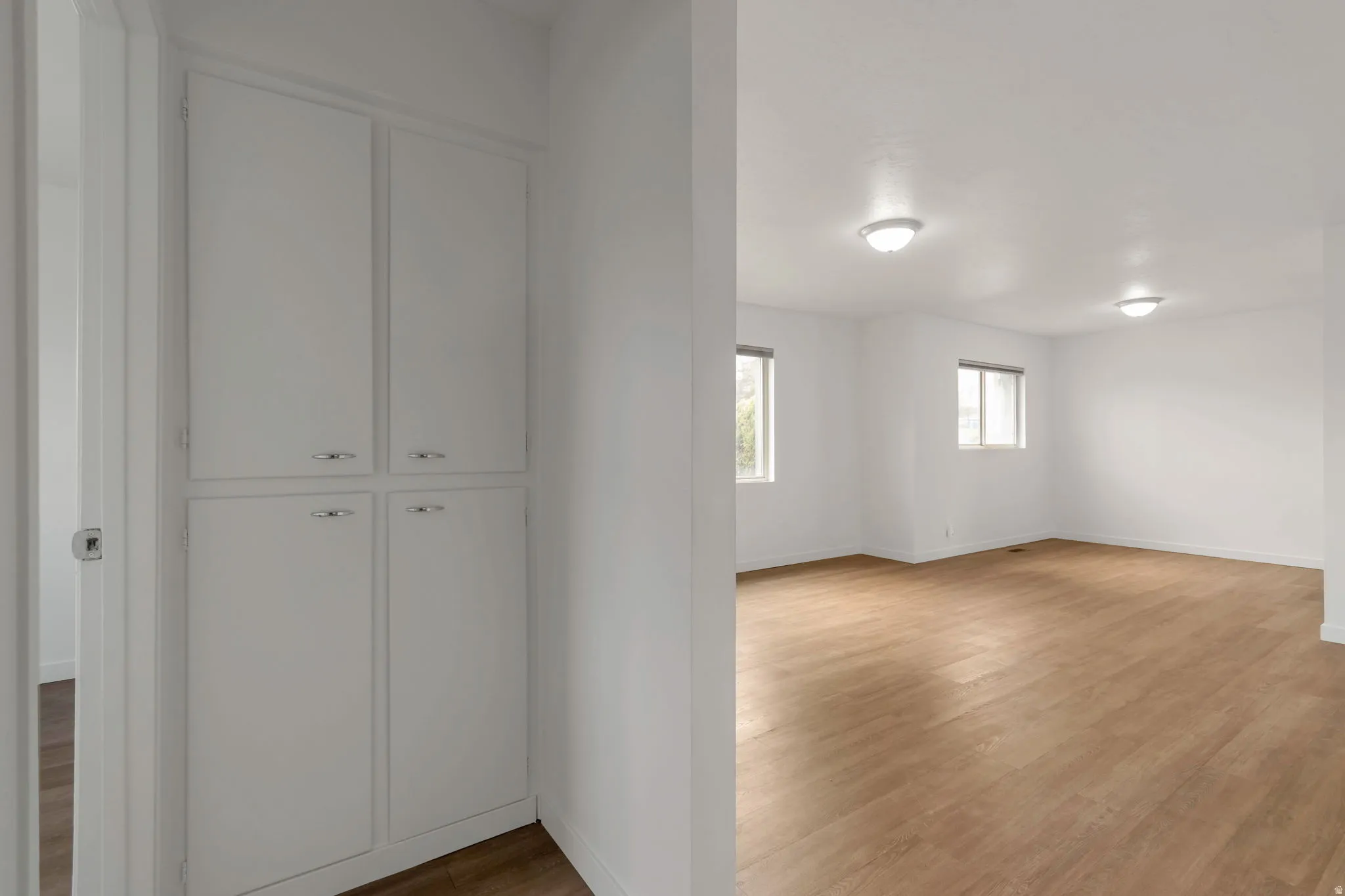Spare room featuring wood finished floors and baseboards