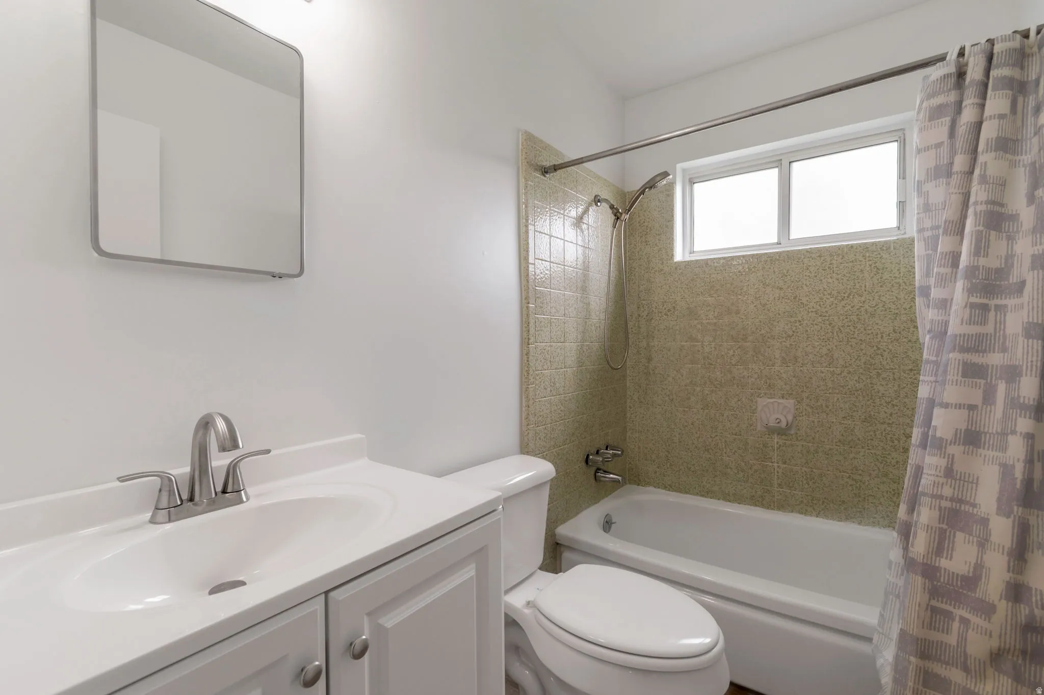 Full bathroom featuring vanity and shower / tub combo with curtain