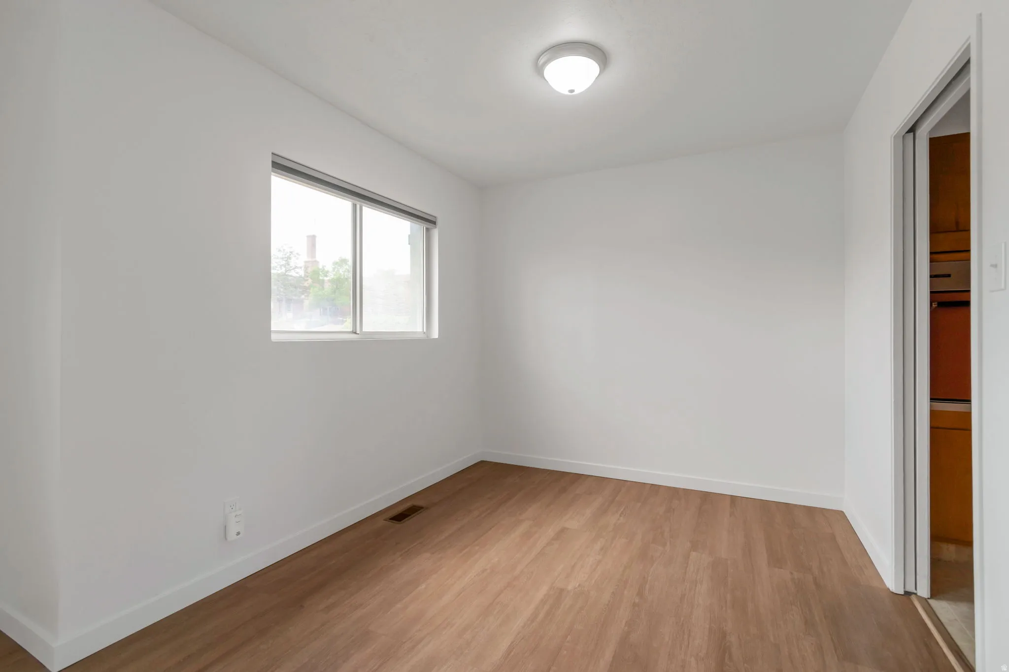 Unfurnished bedroom featuring baseboards and light wood-type flooring