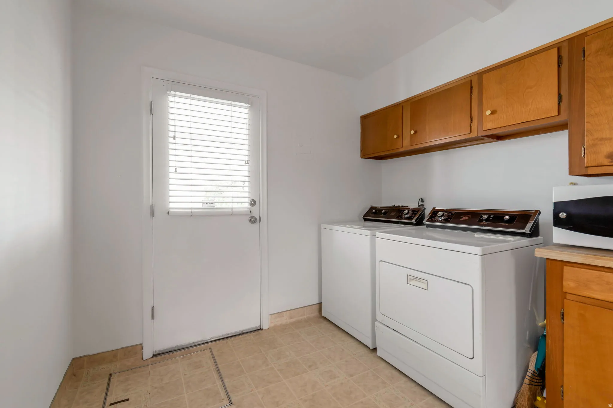Laundry room featuring cabinet space and independent washer and dryer