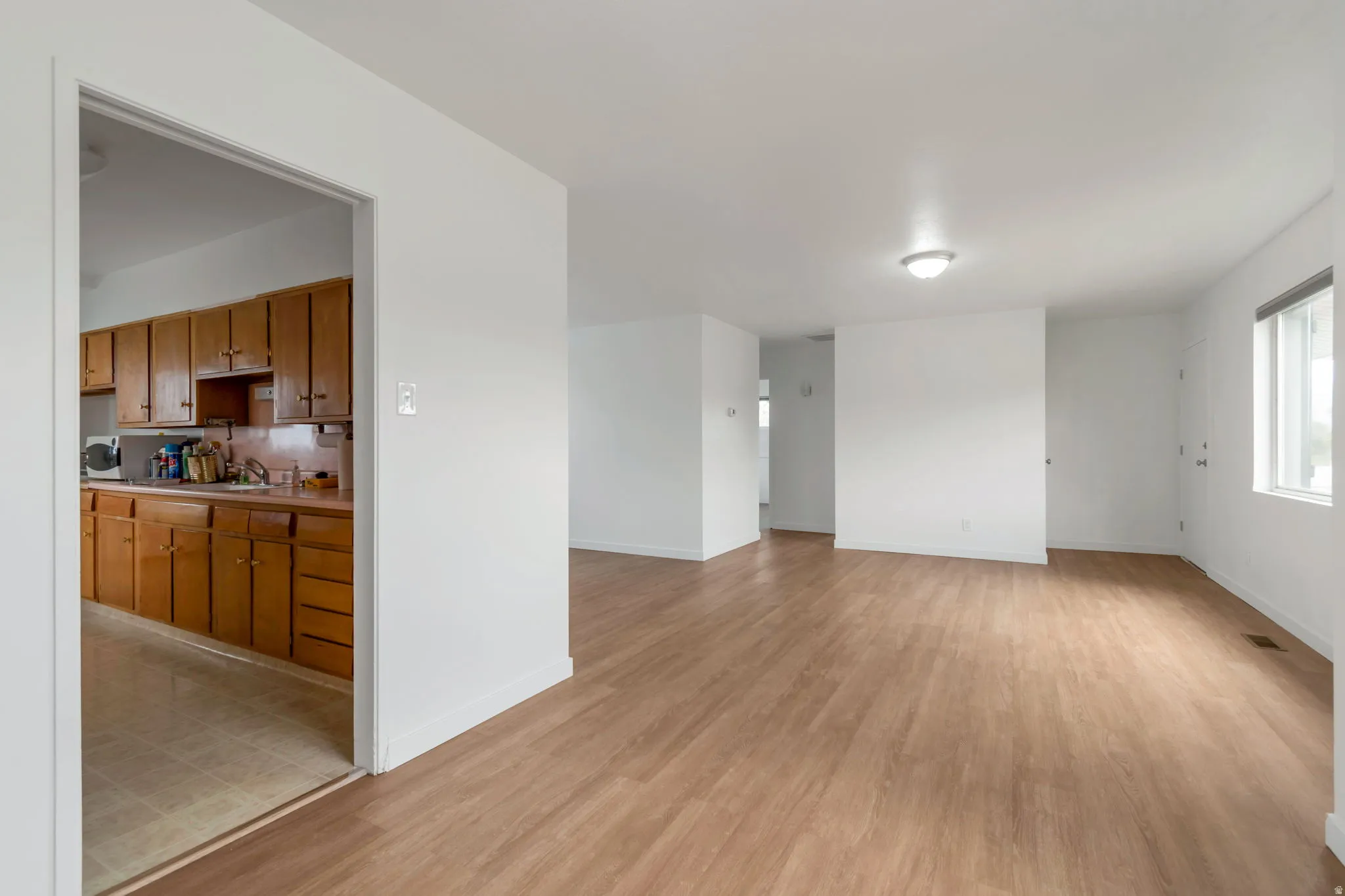 Unfurnished living room with light wood-type flooring
