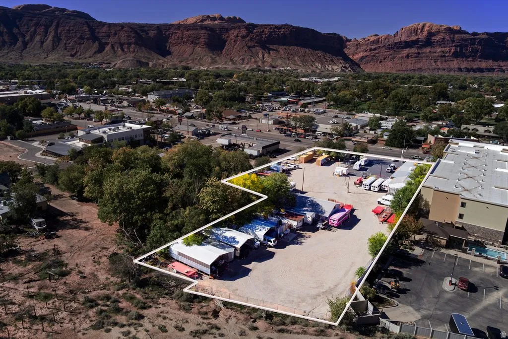View of property location with a mountainous background, property boundaries highlighted, and nearby suburban area