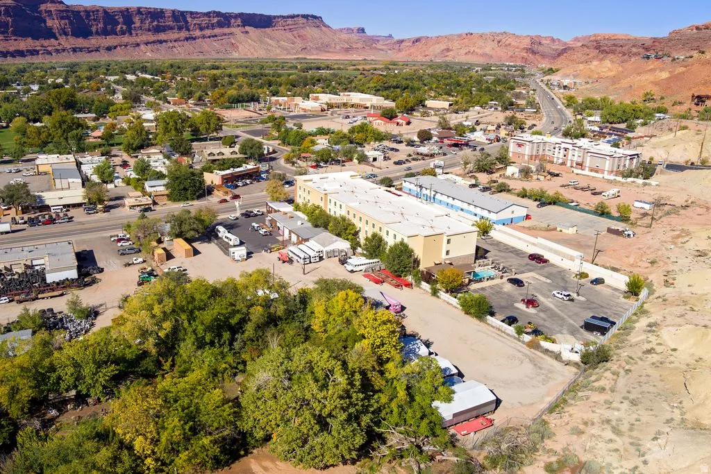Aerial view of property's location featuring a mountainous background