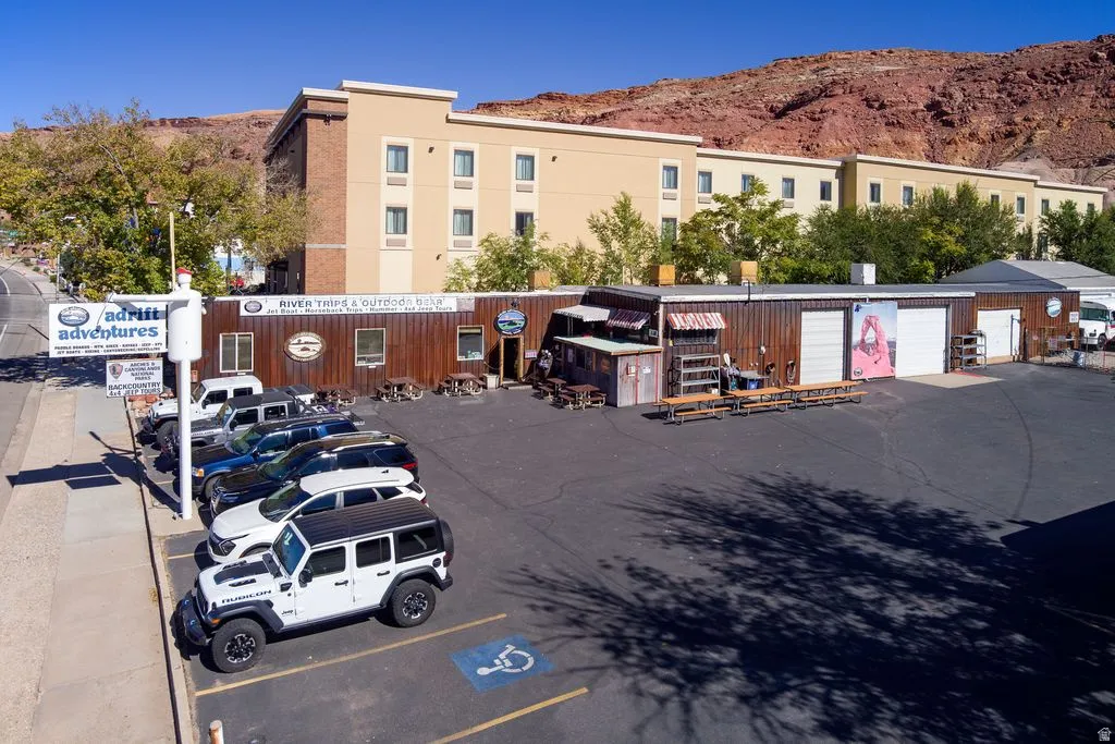 View of commercial location with uncovered parking and a mountain view