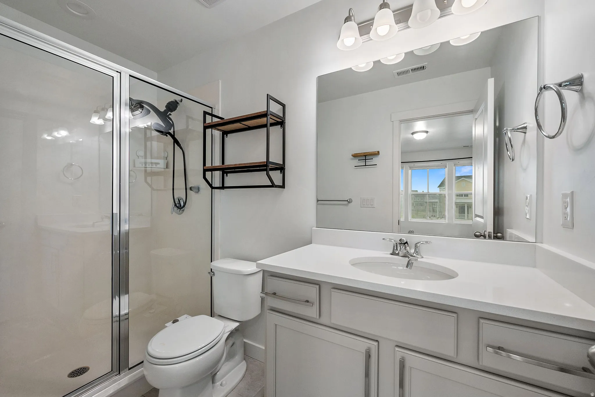 Full bathroom with vanity and a shower stall
