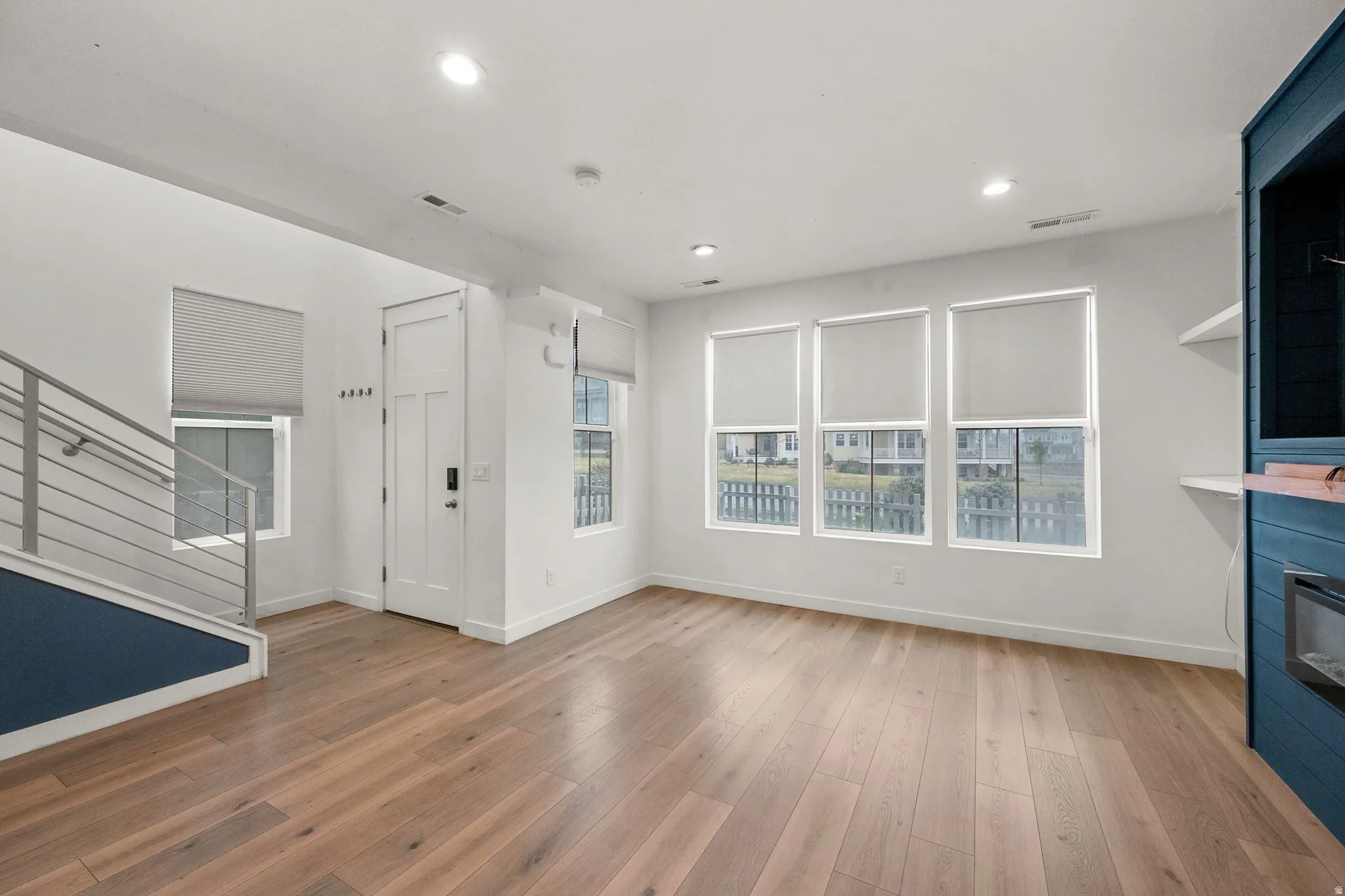 Unfurnished living room with a glass covered fireplace, hardwood / wood-style floors, and recessed lighting
