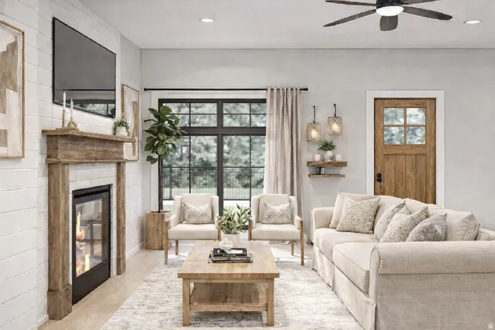 Living room with a glass covered fireplace, light wood finished floors, a ceiling fan, and recessed lighting