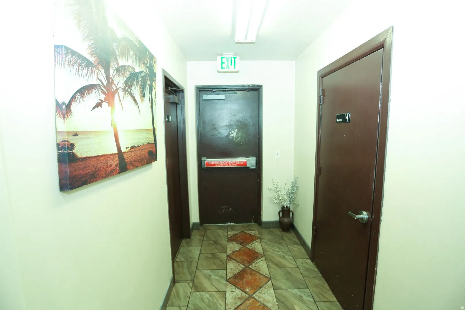 Hallway with baseboards and elevator