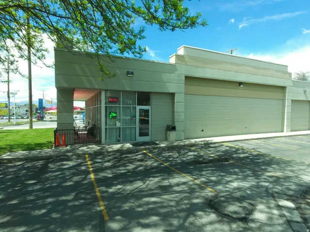 View of commercial property featuring uncovered parking