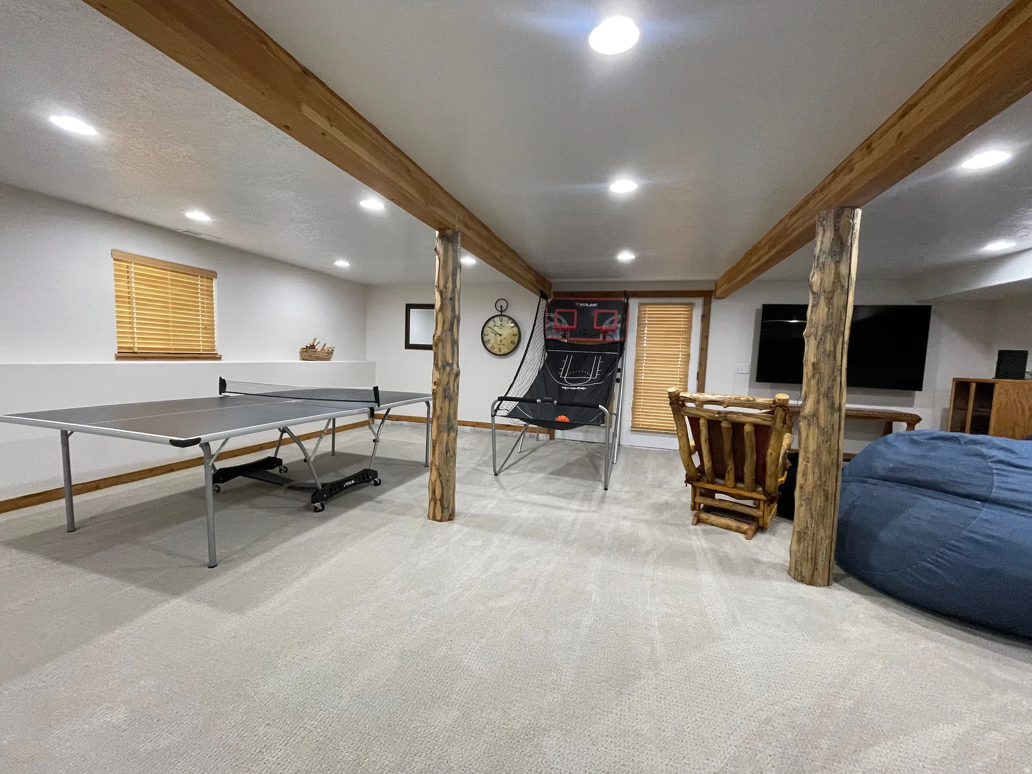 Game room featuring recessed lighting, light carpet, and beamed ceiling