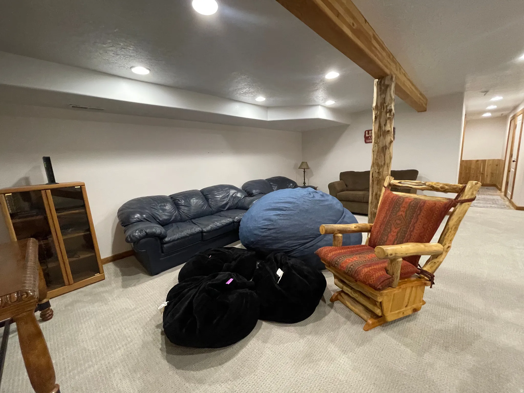 Living room with recessed lighting, light carpet, and beamed ceiling