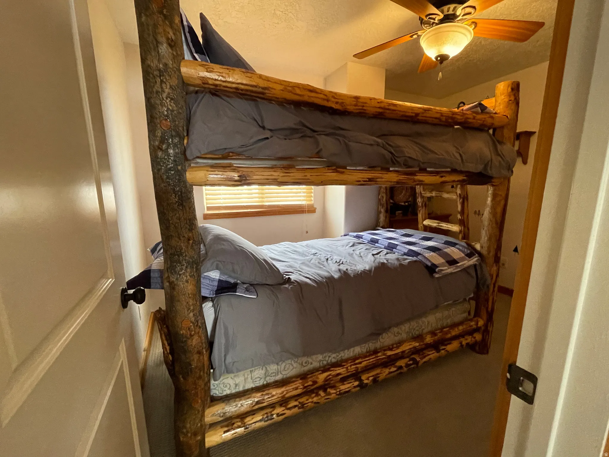 Bedroom featuring a textured ceiling and ceiling fan
