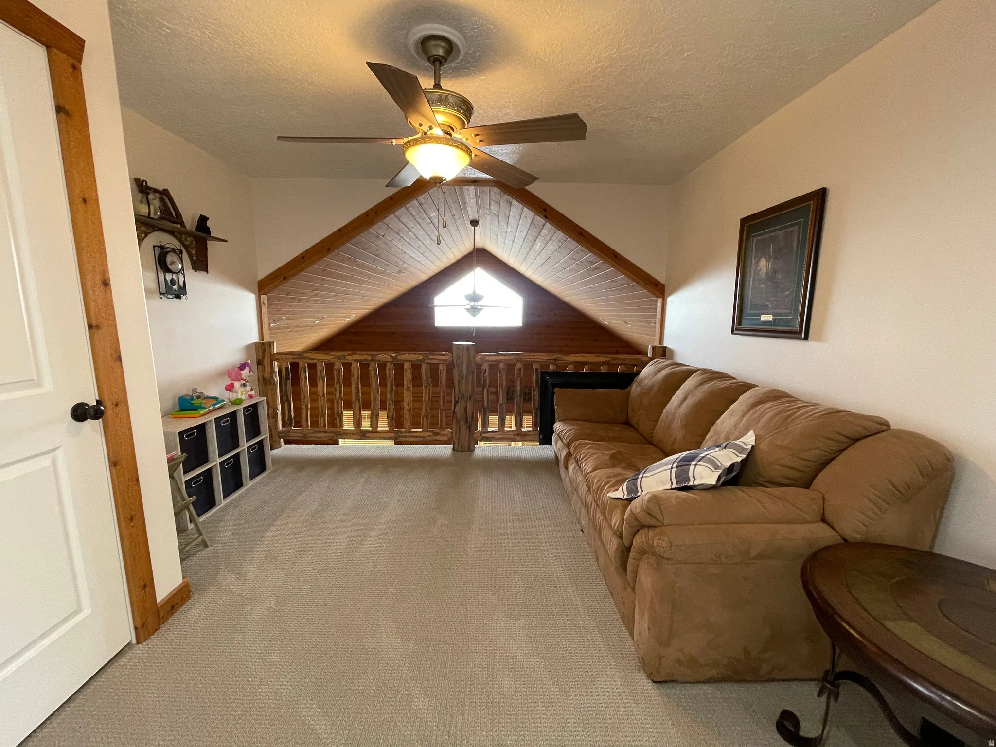 Sitting room with a ceiling fan and light carpet